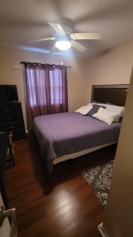 bedroom featuring ceiling fan and dark hardwood / wood-style flooring