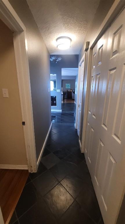 hallway featuring a textured ceiling