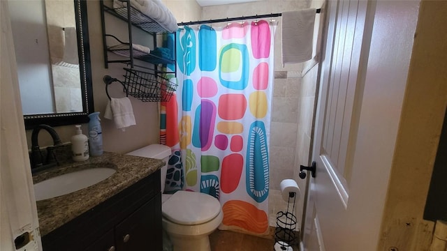 bathroom featuring vanity, a shower with shower curtain, and toilet