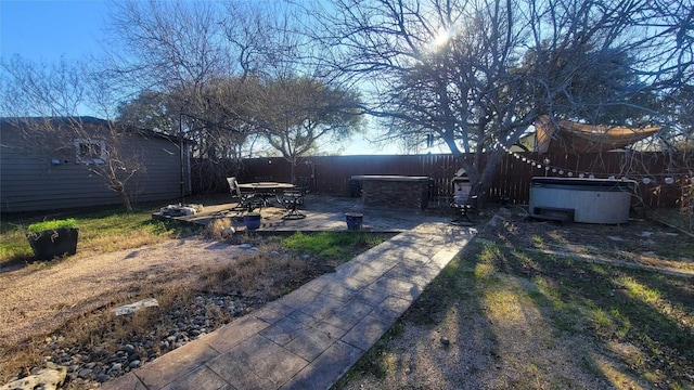 12410 Twin Creek Rd, Manchaca, TX 78652 - view of yard with an outdoor structure, a fenced backyard, a hot tub, and a patio