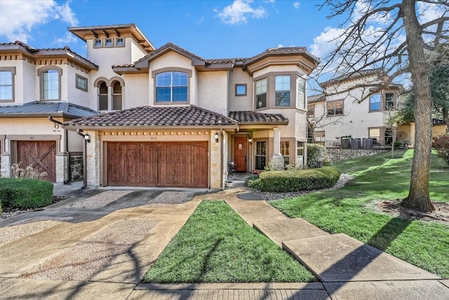 mediterranean / spanish-style house featuring a garage and a front yard