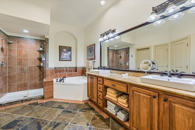 bathroom featuring vanity, separate shower and tub, and tile walls