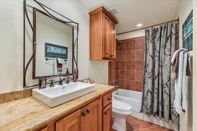 full bathroom with shower / tub combo, vanity, tile patterned floors, and toilet