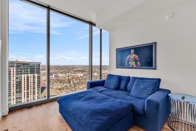 living room featuring hardwood / wood-style flooring and a wall of windows