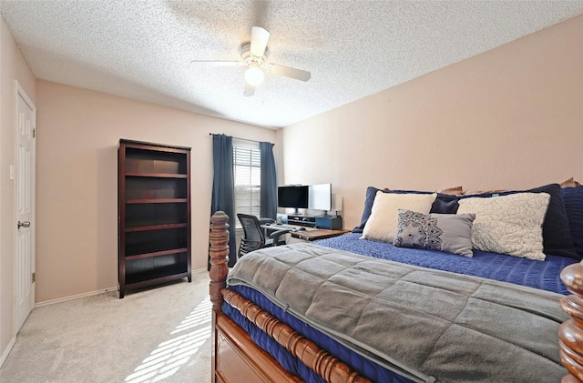 bedroom featuring light carpet, a textured ceiling, and ceiling fan