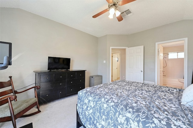 carpeted bedroom featuring ceiling fan, lofted ceiling, and connected bathroom