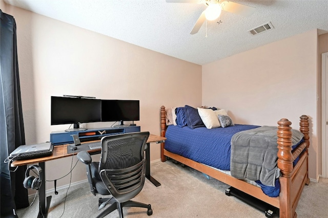 carpeted bedroom featuring a textured ceiling and ceiling fan