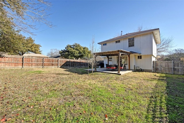 rear view of property with a yard, a pergola, and a patio area