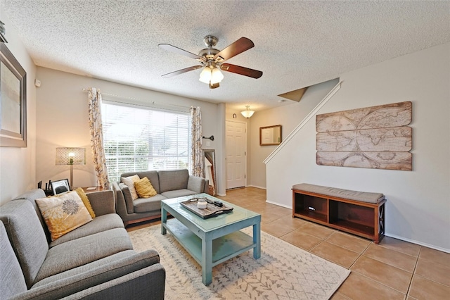 tiled living room with ceiling fan and a textured ceiling