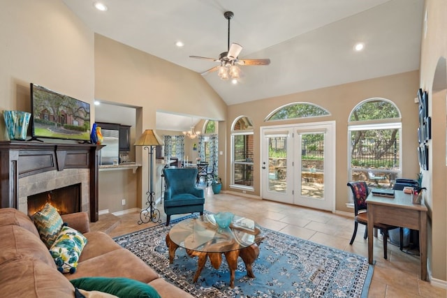 tiled living room with high vaulted ceiling, a fireplace, and ceiling fan with notable chandelier