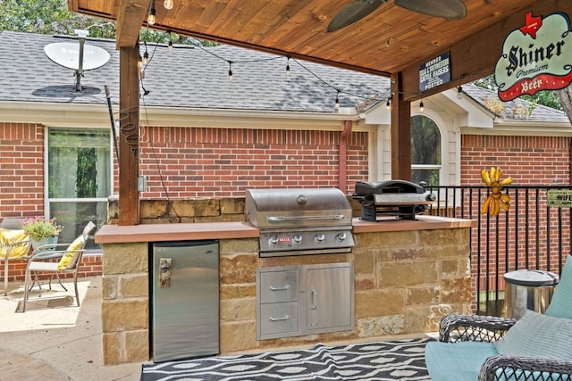 view of patio / terrace with exterior kitchen, a grill, and ceiling fan