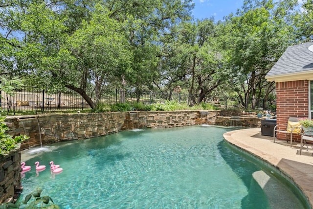 view of pool with pool water feature and a patio area