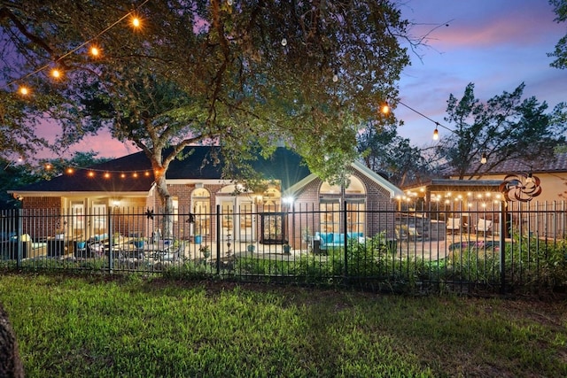 pool at dusk featuring a patio