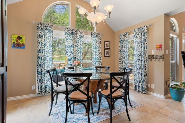 tiled dining area with lofted ceiling and a notable chandelier