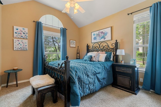 carpeted bedroom featuring multiple windows, lofted ceiling, and ceiling fan