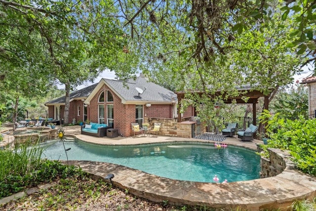 view of pool with a patio, outdoor lounge area, and an in ground hot tub