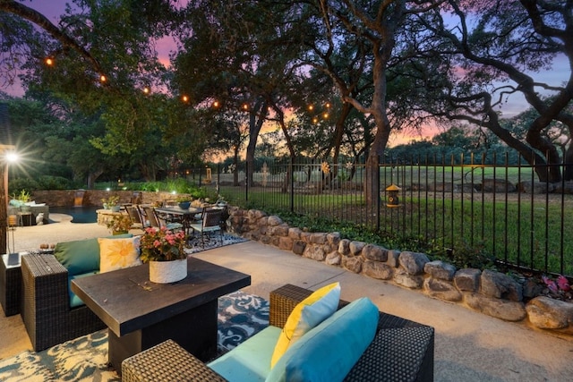 patio terrace at dusk featuring an outdoor living space