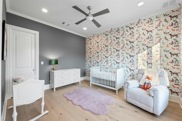 bedroom featuring ornamental molding, ceiling fan, and light wood-type flooring