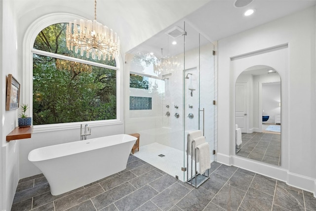 bathroom featuring an inviting chandelier, radiator, and shower with separate bathtub