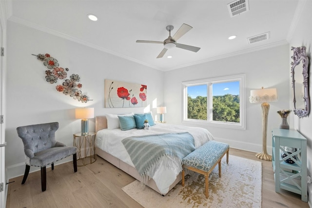 bedroom with ceiling fan, ornamental molding, and light hardwood / wood-style floors