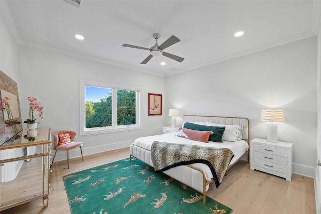 bedroom featuring ornamental molding, ceiling fan, and light hardwood / wood-style floors