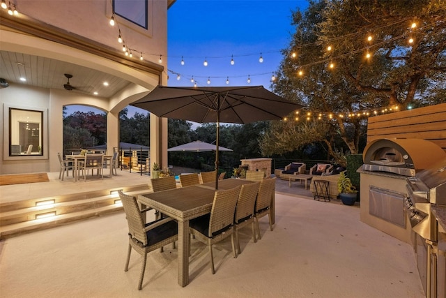 view of patio featuring a fireplace and ceiling fan