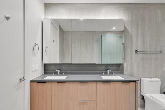 bathroom featuring vanity, tile walls, an enclosed shower, and toilet