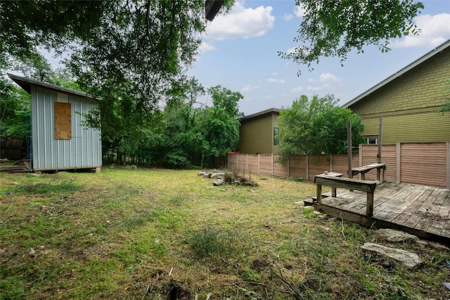 view of yard with a storage shed and a wooden deck