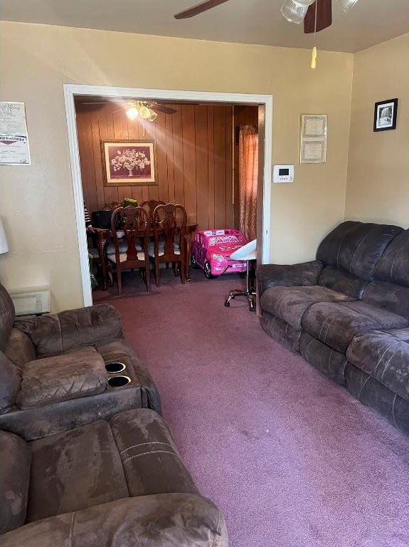 living room featuring carpet and ceiling fan