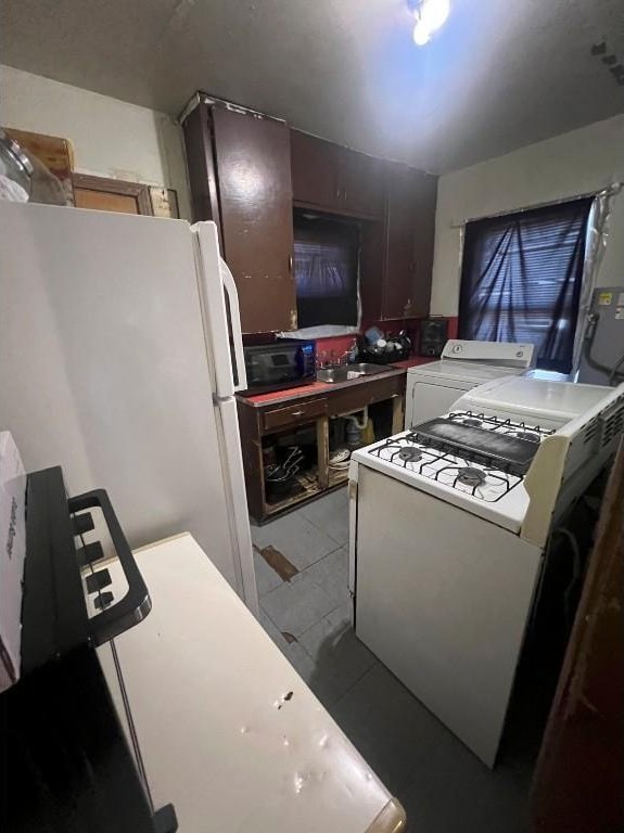 kitchen featuring washer / clothes dryer, white fridge, dark brown cabinets, and sink