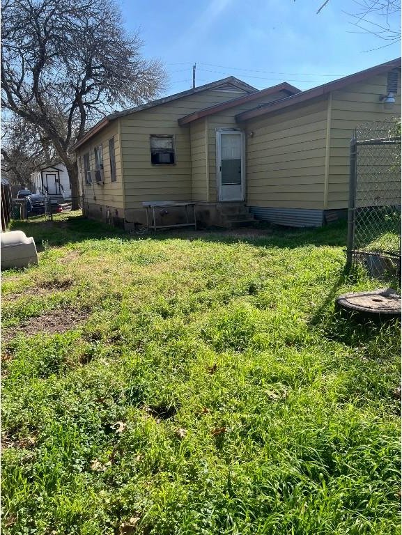 rear view of house featuring a lawn