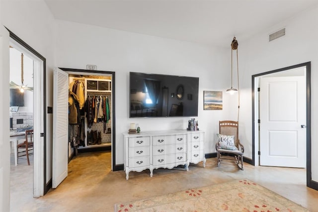 bedroom featuring a walk in closet and a closet