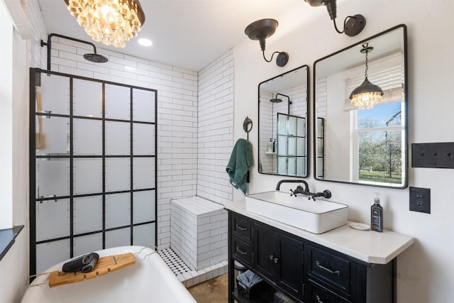 bathroom featuring vanity, tiled shower, and a notable chandelier