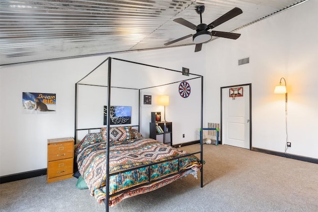 carpeted bedroom with high vaulted ceiling and ceiling fan