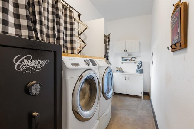 clothes washing area with cabinets and separate washer and dryer