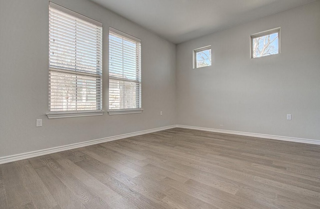 unfurnished room with wood finished floors and baseboards