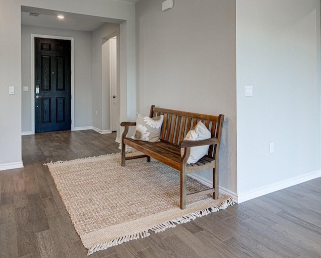 interior space featuring baseboards and wood finished floors