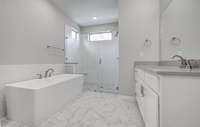 full bath with a shower stall, a freestanding bath, and vanity