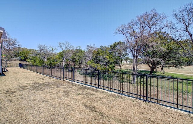 exterior space with a lawn and fence