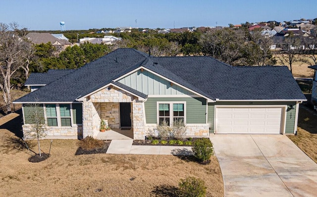 view of front of home featuring board and batten siding, concrete driveway, roof with shingles, and an attached garage