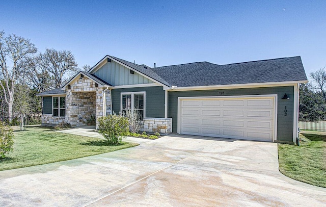 view of front of home featuring a garage, a front yard, stone siding, board and batten siding, and driveway