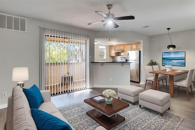 living room with ceiling fan and light wood-type flooring