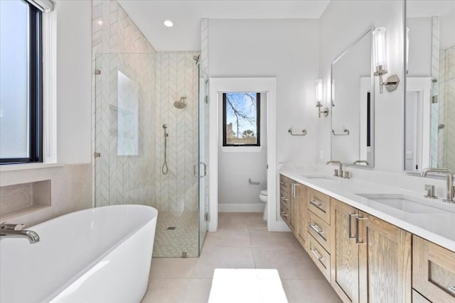 full bathroom with tile patterned floors, toilet, separate shower and tub, and vanity