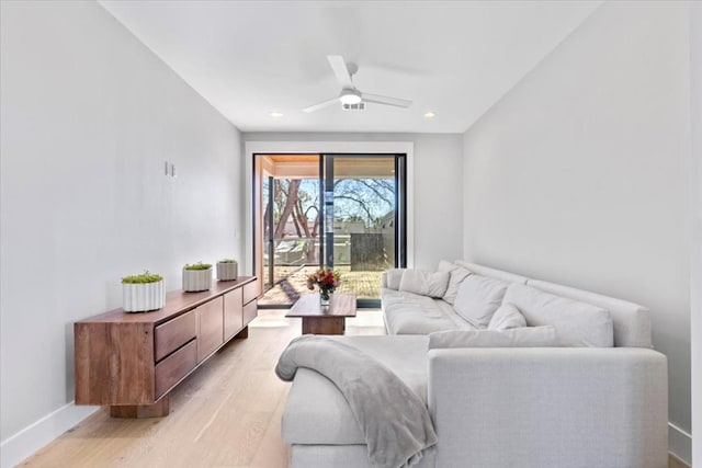 living room featuring ceiling fan and light wood-type flooring