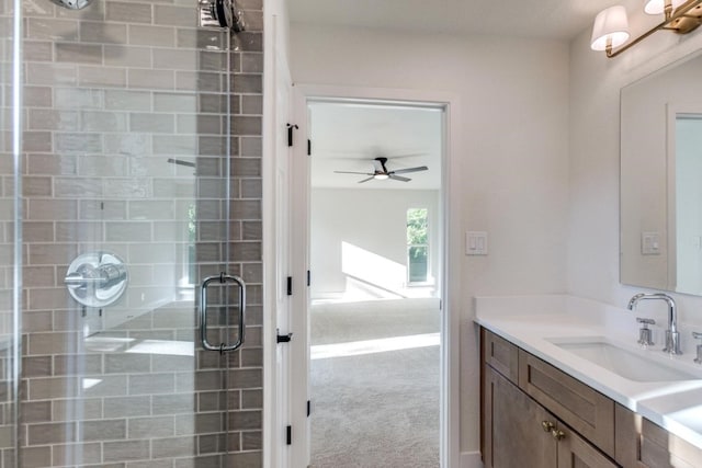 bathroom with vanity, ceiling fan, and walk in shower