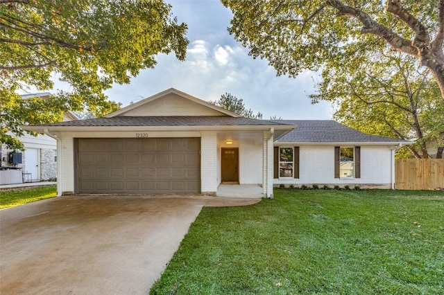 single story home featuring a garage and a front yard