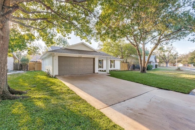 single story home with a garage and a front lawn