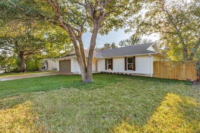 ranch-style home featuring a garage and a front lawn