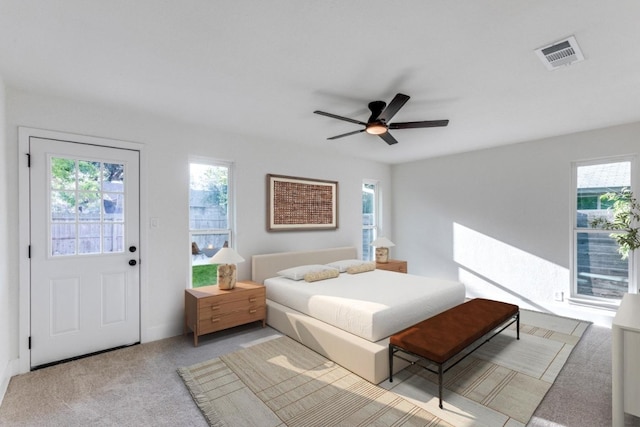 bedroom featuring access to outside, light colored carpet, and ceiling fan