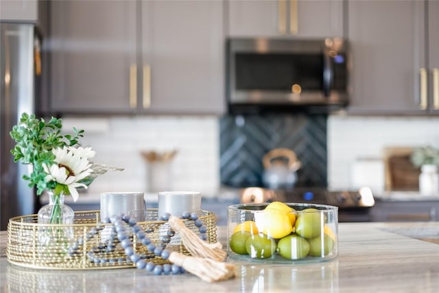 detailed view of stainless steel microwave and gray cabinets